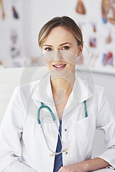 Portrait of smiling female doctor in her doctorÃ¢â¬â¢s office photo
